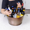 Circle metal bucket with hammered exterior and swing handles.  Chills drinks with ice for parties.