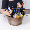 Circle metal bucket with hammered exterior and swing handles.  Chills drinks with ice for parties.