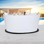 White galvanized bucket drink cooler with rubber bar mat for parties in the home.  Great for use indoors or outdoors on the patio.  The cocktail bar mat prevents irritating party messes.